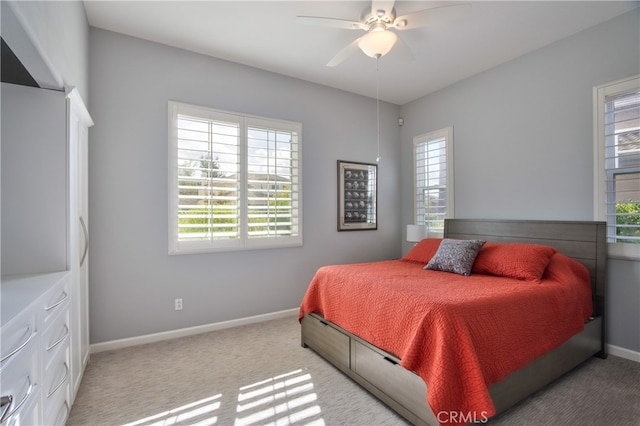 bedroom with ceiling fan and light colored carpet