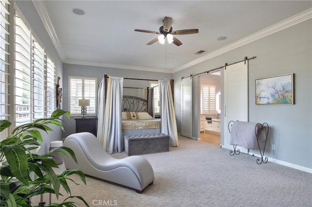 bedroom featuring a barn door, light colored carpet, ensuite bath, and ceiling fan