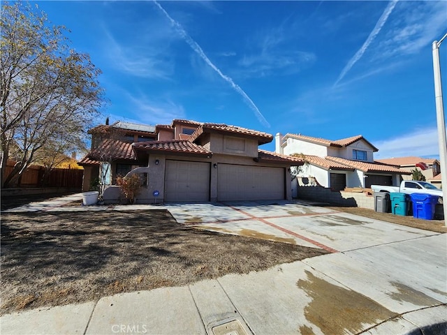 mediterranean / spanish-style home with a garage