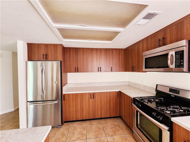 kitchen featuring light tile patterned floors and appliances with stainless steel finishes