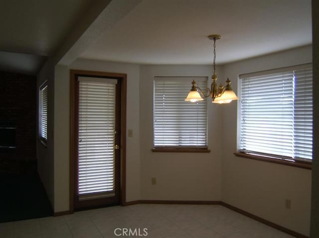 unfurnished dining area featuring an inviting chandelier