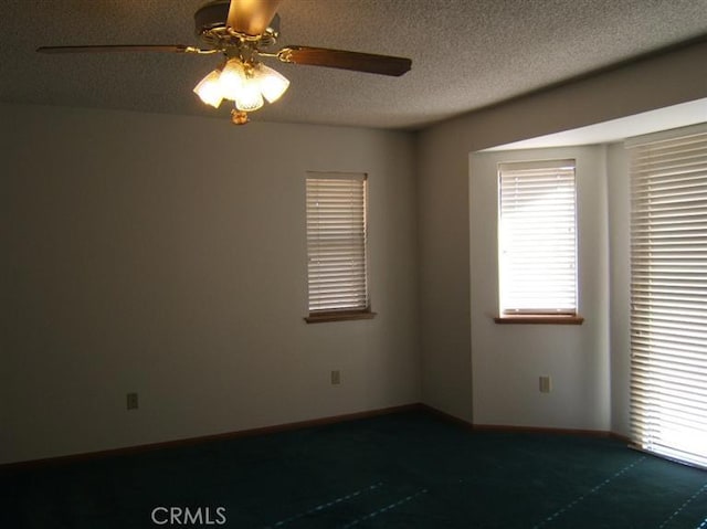 empty room featuring carpet flooring, ceiling fan, and a textured ceiling