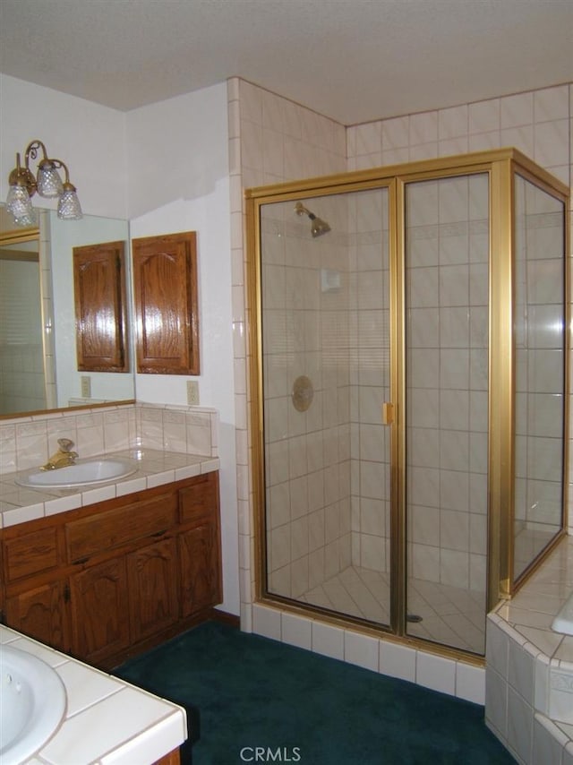 bathroom featuring vanity and an enclosed shower