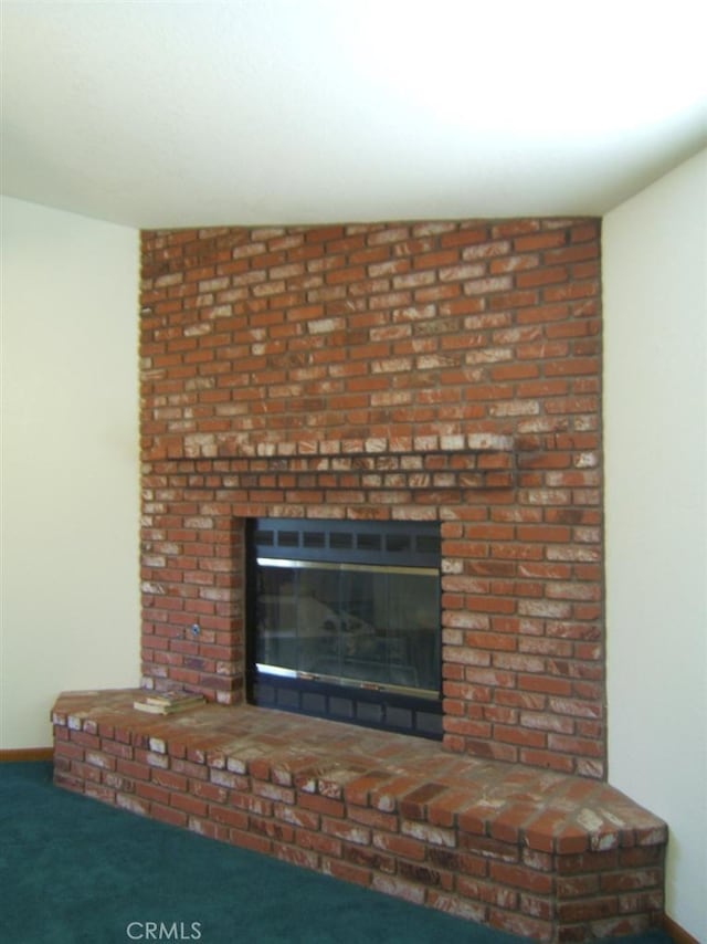 room details featuring a fireplace and carpet flooring