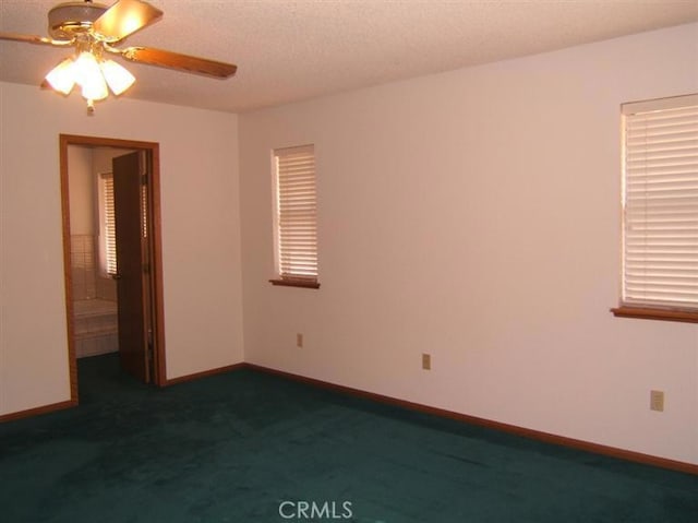 carpeted empty room featuring a textured ceiling and ceiling fan