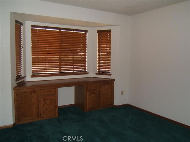 unfurnished office with dark carpet