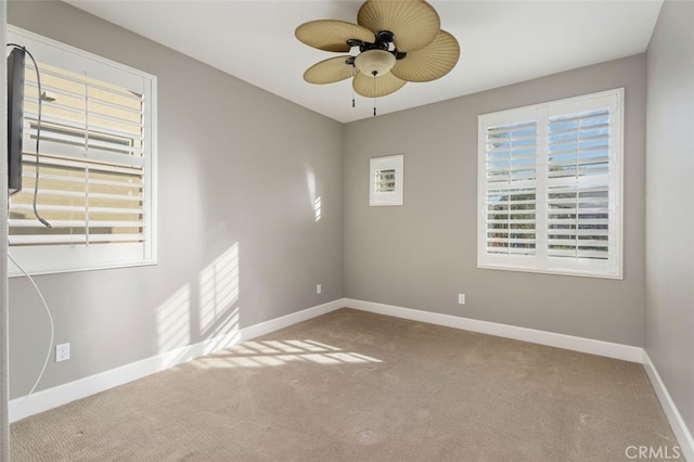 carpeted empty room featuring ceiling fan