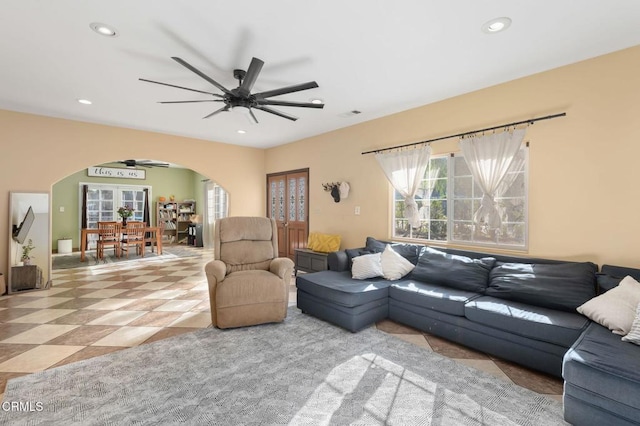 living room with ceiling fan and french doors