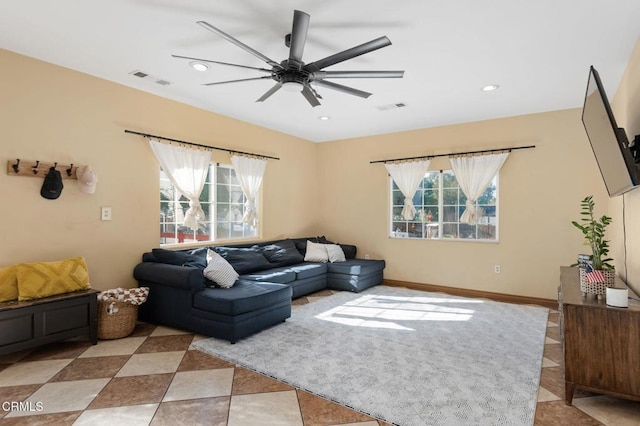 living room featuring ceiling fan and plenty of natural light