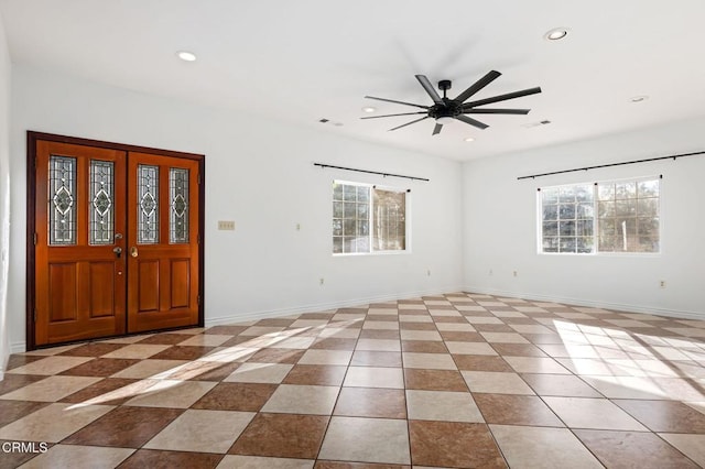 entryway featuring baseboards, a wealth of natural light, and recessed lighting