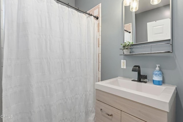 bathroom with curtained shower and vanity