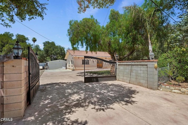 exterior space featuring a fenced front yard and a gate