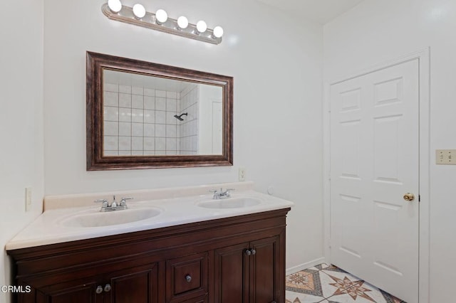 bathroom with double vanity, a sink, and baseboards