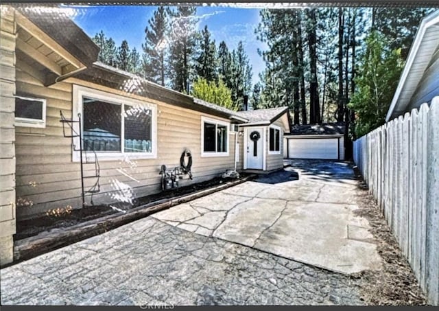 view of patio with a garage and an outdoor structure