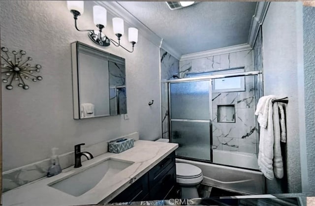 full bathroom with crown molding, a textured ceiling, toilet, shower / bath combination with glass door, and vanity