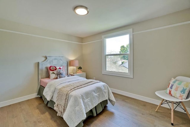 bedroom with hardwood / wood-style flooring