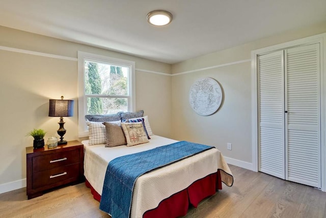 bedroom featuring light hardwood / wood-style flooring and a closet