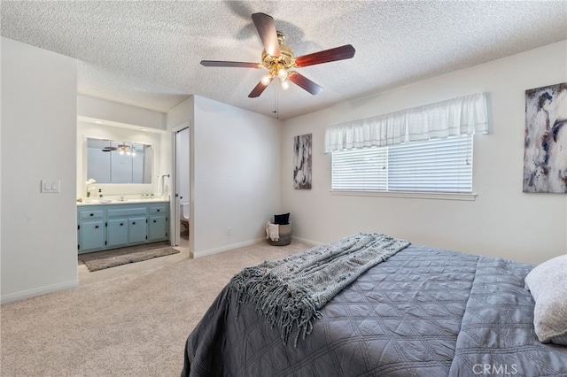 carpeted bedroom featuring a textured ceiling, connected bathroom, and ceiling fan