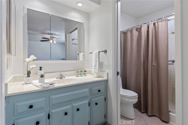 bathroom with tile patterned floors, toilet, vanity, and curtained shower