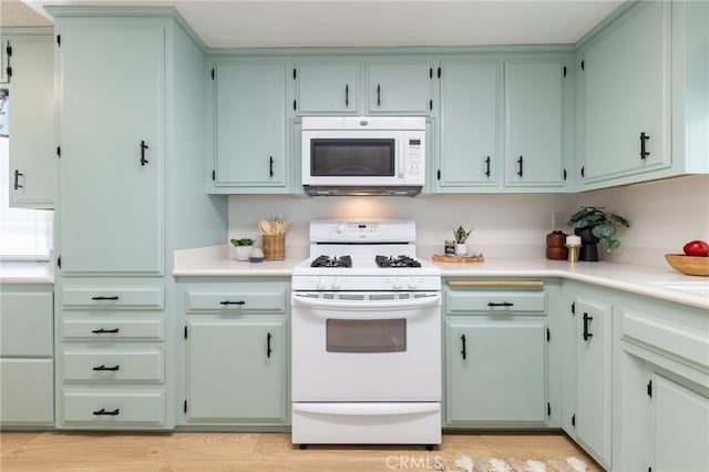 kitchen with white appliances and light wood-type flooring