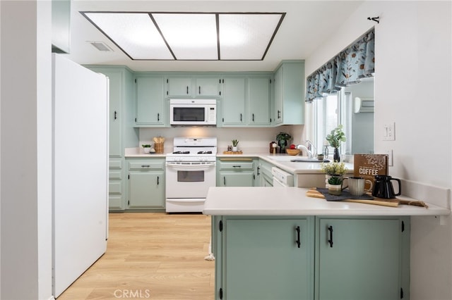 kitchen with white appliances and green cabinetry