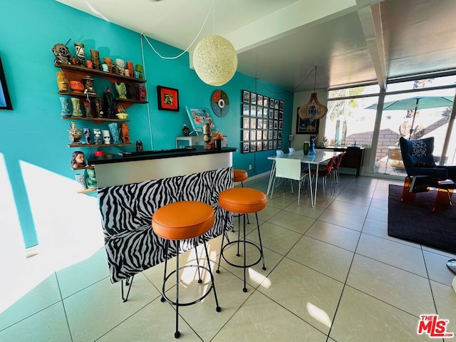 bar featuring tile patterned flooring and floor to ceiling windows