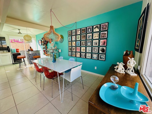 tiled dining area with ceiling fan and beverage cooler