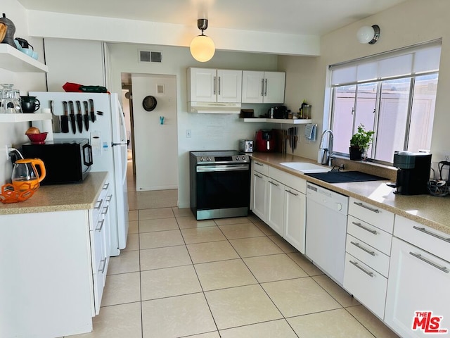 kitchen featuring dishwasher, sink, decorative light fixtures, stainless steel range oven, and white cabinetry