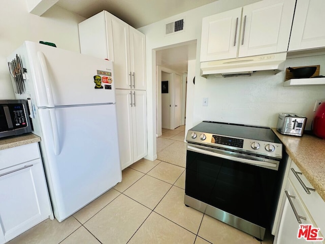 kitchen with white cabinets, light tile patterned floors, and stainless steel appliances