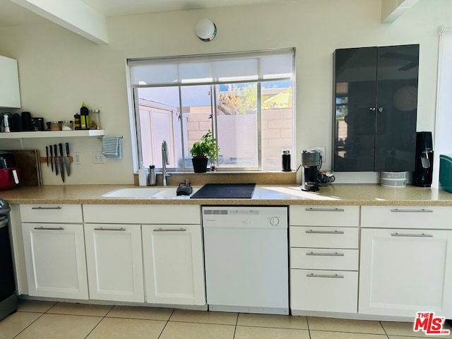 kitchen featuring dishwasher, light tile patterned floors, white cabinets, and sink