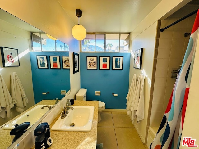 bathroom featuring tile patterned flooring, a shower with shower curtain, toilet, and sink