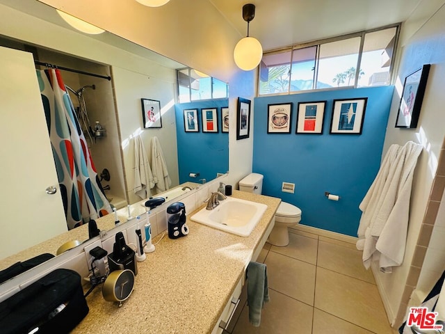 bathroom featuring tile patterned flooring, a shower with curtain, toilet, and vanity