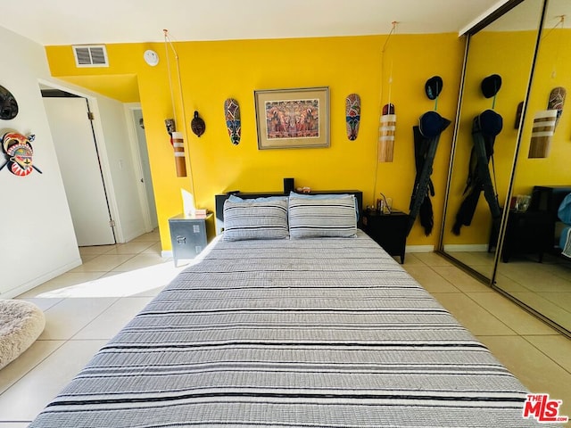 bedroom featuring a closet and light tile patterned floors