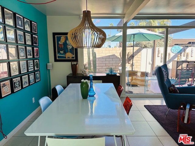 tiled dining room with beamed ceiling