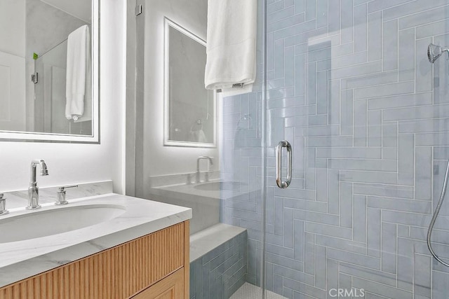 bathroom featuring a stall shower and vanity