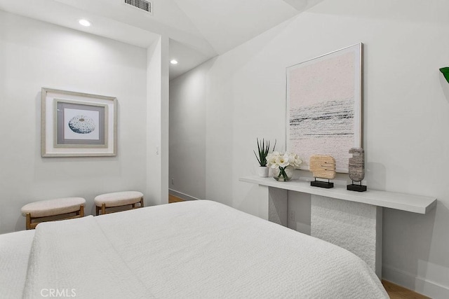 bedroom with recessed lighting, visible vents, baseboards, and wood finished floors