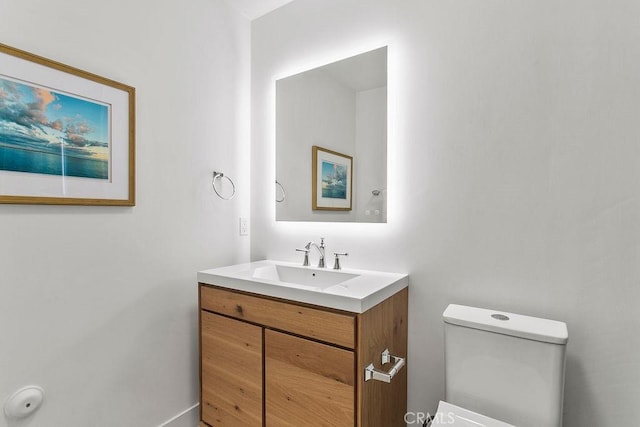 bathroom featuring vanity and toilet