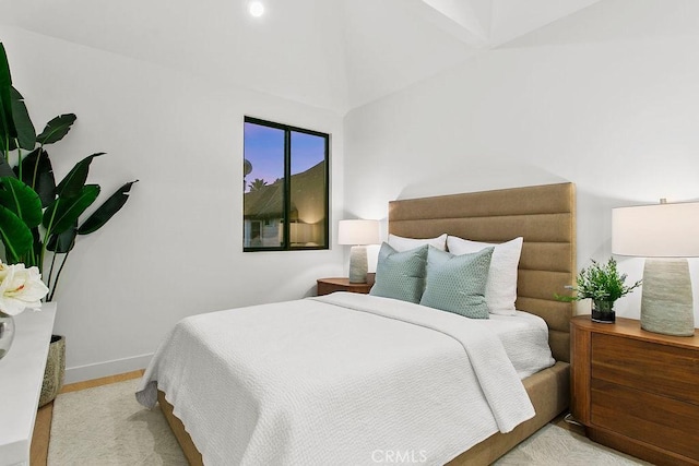 bedroom with baseboards and wood finished floors