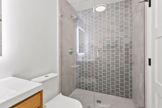 full bath with vanity, toilet, and a shower stall