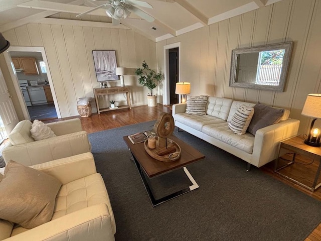 living room featuring dark hardwood / wood-style floors, vaulted ceiling with beams, and ceiling fan