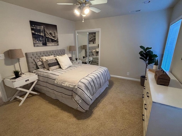 bedroom featuring ceiling fan, a closet, and light colored carpet