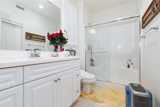 bathroom featuring vanity, an enclosed shower, and toilet