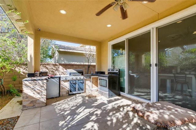 view of patio featuring ceiling fan, exterior kitchen, and sink