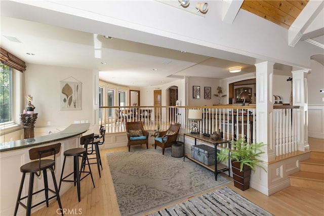 interior space featuring light hardwood / wood-style floors and decorative columns