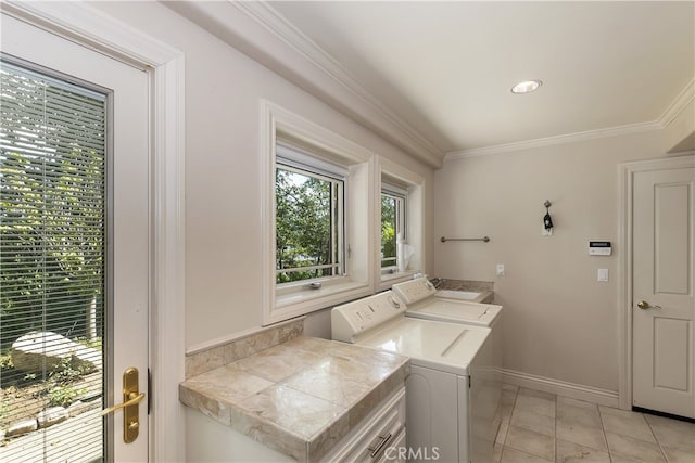 clothes washing area featuring light tile patterned flooring, ornamental molding, and independent washer and dryer