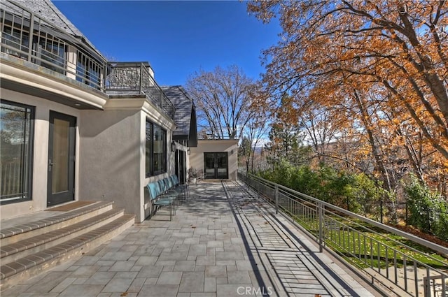 view of patio featuring a balcony