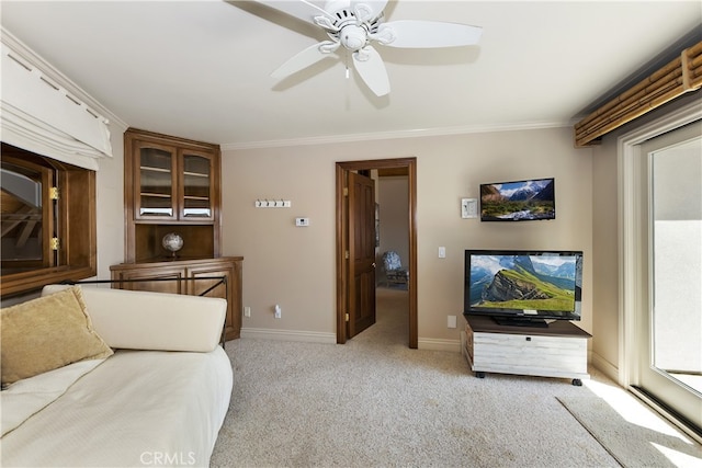 living room with ceiling fan, light carpet, and ornamental molding