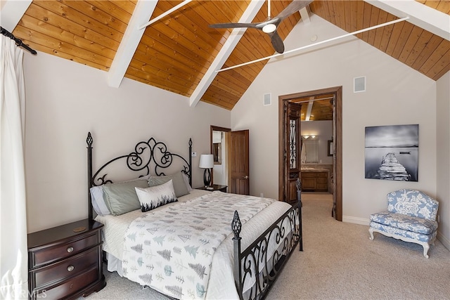 carpeted bedroom with wooden ceiling, beam ceiling, high vaulted ceiling, and ensuite bath