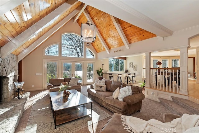 living room with an inviting chandelier, carpet floors, a fireplace, high vaulted ceiling, and beamed ceiling