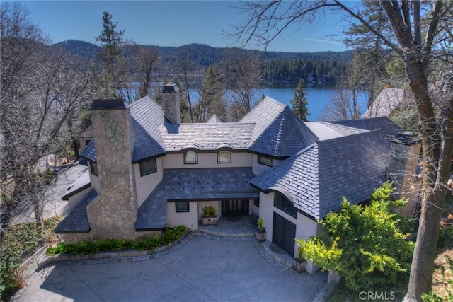 view of property featuring a water and mountain view and a garage